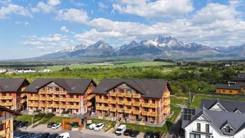 an aerial view of a resort with mountains in the background at Tatry PANORAMA apartmány Tatragolf in Tatranská Lomnica