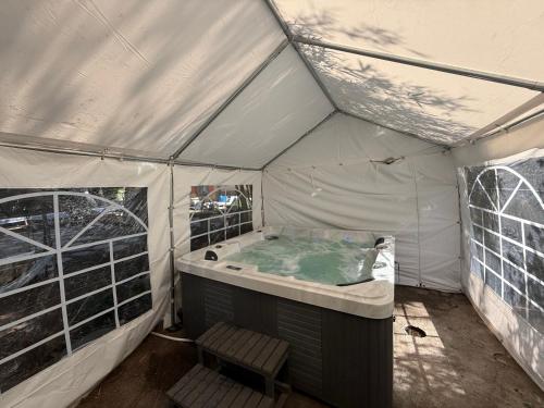 a hot tub in a tent with a bench in it at Gross Nofesh and Spa Guesthouse in Bet Hillel