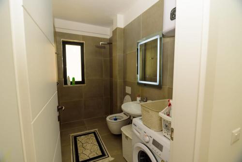 a small bathroom with a toilet and a sink at Seaside Serenity Apartments - Tirana Resort Radhime in Vlorë