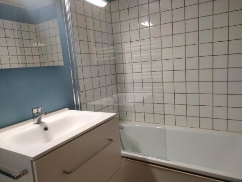 une salle de bain avec un lavabo, une douche et une baignoire dans l'établissement Ref 065 Appartement duplex pour sept personnes plage à pied Arzon, à Arzon