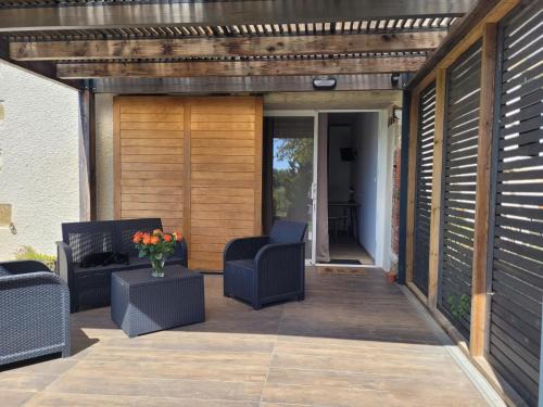 an outdoor patio with two chairs and a table at La Gurlanne in Lasséran
