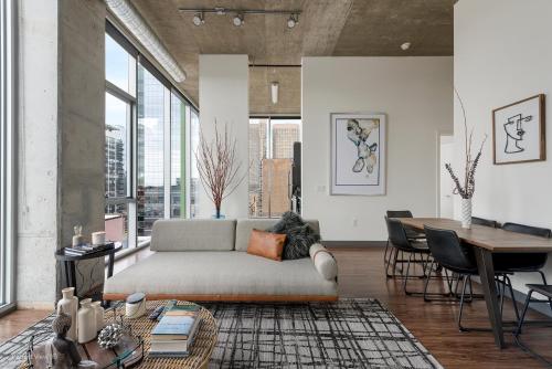 a living room with a couch and a table at Jeffjack Heated Pool Penthouse in Chicago's West Loop in Chicago