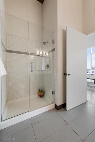 a shower with a glass door in a bathroom at Jeffjack Heated Pool Penthouse in Chicago's West Loop in Chicago