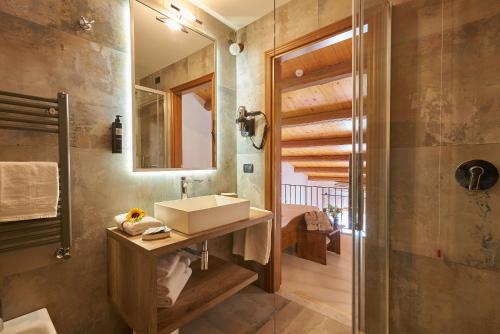 a bathroom with a sink and a mirror at Casanova - Panoramic Rooms and Suites in San Quirico dʼOrcia