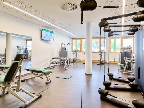 a gym with several treadmills and exercise equipment at DAS SIEBEN - Adults Only in Bad Häring