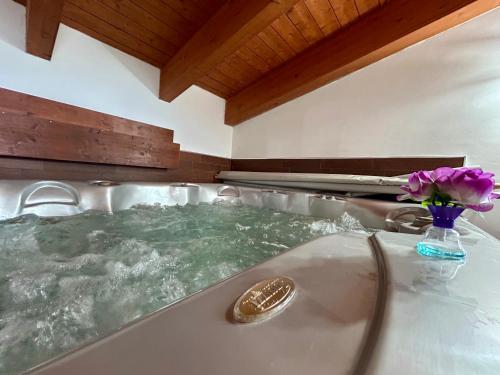 a bath tub with a vase of flowers in it at LA VILLA IN CAMPAGNA in Citta' Sant'Angelo