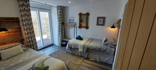 a bedroom with two beds and a window in it at Detached with Amazing Sea Views and Hot Tub in Llandudno
