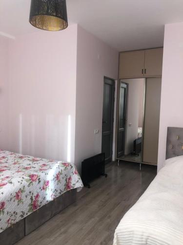 a bedroom with a bed and a dresser and a mirror at Syune Syunick Shinuhayr in Shinuhayr
