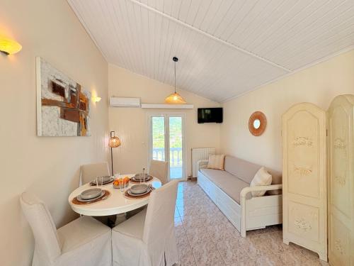 a living room with a table and a couch at Myrtos Hotel in Divarata