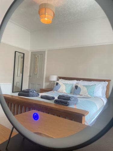 a bedroom with a bed with a mirror at 2025 Traveller award winner Just bring clothes in West Kirby
