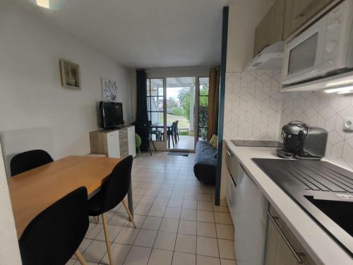 une cuisine avec une table et une salle à manger dans l'établissement Studio 4 pers / terrasse / espace aquatique, à Talmont-Saint-Hilaire