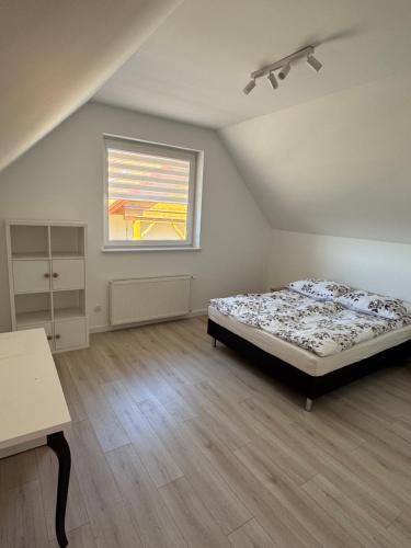 a bedroom with a bed and a window at Ranczo Ryki in Nowy Dwór Gdański