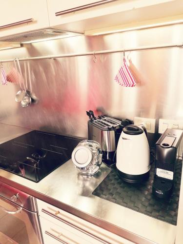 a kitchen with a counter top with pots and pans at Dimora San Paolo in Vicenza