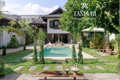 a villa with a swimming pool in front of a house at Private Pool, 8-Bedroom, Old Town, Entire Estate - TANPURI Thapea - Prime Location in Chiang Mai