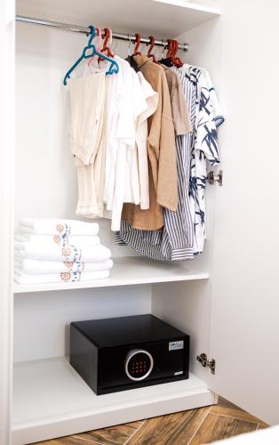 a walk in closet with a scale and clothes at CAPTAIN'S RESIDENCE in Ksamil