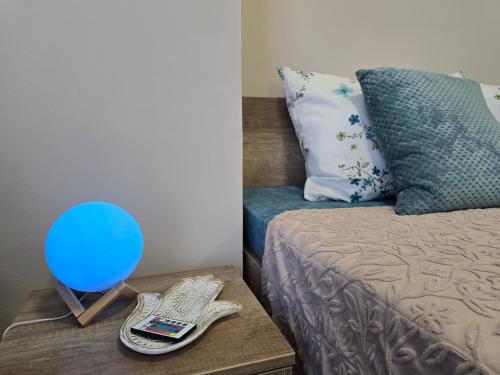 a bedroom with a bed with a blue ballon on a table at MA DONNA rooms in Floreşti
