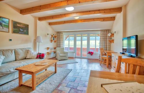 a living room with a couch and a table at Apartmány nad stájemi - Jítravský Dvorec in Rynoltice
