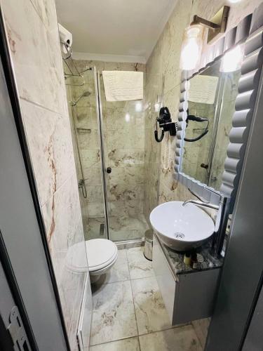 a bathroom with a shower and a toilet and a sink at City Center Hotel Taksim İstanbul in Istanbul