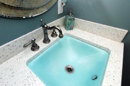 a sink in a bathroom with a blue at Pocasset Village Charmer in Pocasset