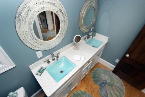 a bathroom with a sink and a mirror at Pocasset Village Charmer in Pocasset