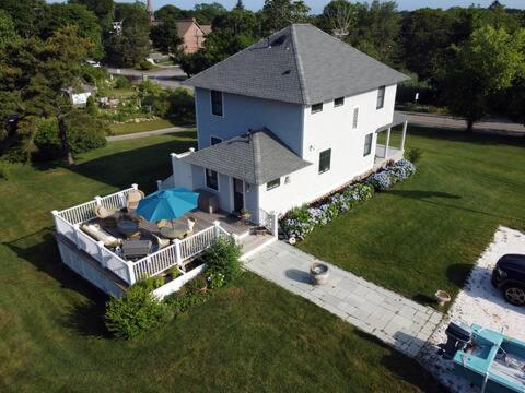 an aerial view of a white house with a patio at Pocasset Village Charmer in Pocasset