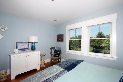 a bedroom with a bed and a window at Pocasset Village Charmer in Pocasset