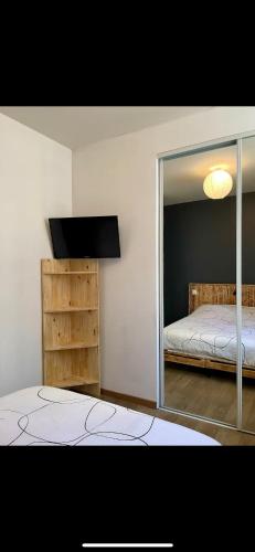a bedroom with a mirror and a bed in it at Chez Louis in Saint-Flour