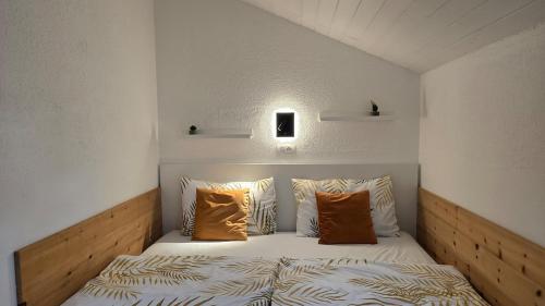 a bedroom with a bed with orange pillows at Hike, Bike & More in Parcines