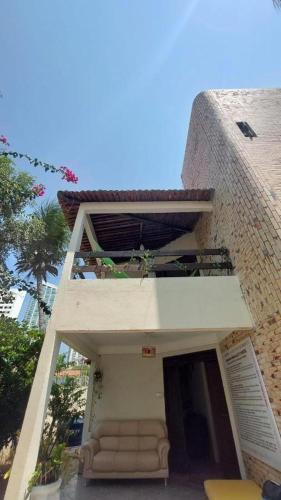 a building with a couch sitting outside of it at Get Up Hostel in Natal