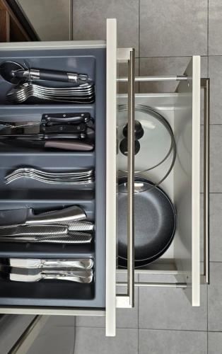 a drawer with silver utensils in a kitchen at Hike, Bike & More in Parcines