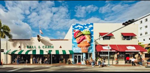 a street corner in a city with a building with a giant ice cream sign at Beds & Sheets little Havana in Miami