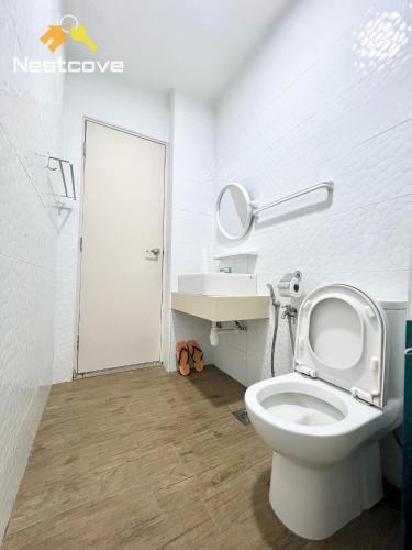 a white bathroom with a toilet and a sink at The Quartz Residence & Suites Infinity Pool By Nestcove in Melaka