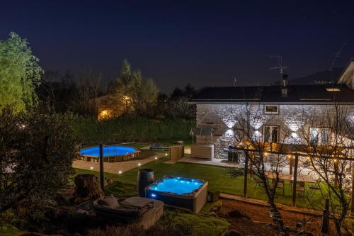 a backyard with a pool and a house at night at k10 Luxury House, Pool, Jacuzzi, Gym, Private Garden in Lipomo