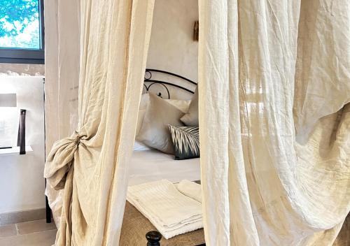 a bedroom with a bed with a canopy at Luxury Suite & Spa Trullo Monte Farella in Putignano