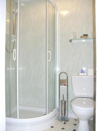 a bathroom with a shower and a toilet at The Pebbles - Adults Only in Weymouth