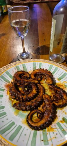 a plate of snakes on a table with a glass at Hotel boutique Pukarainca in Uspallata