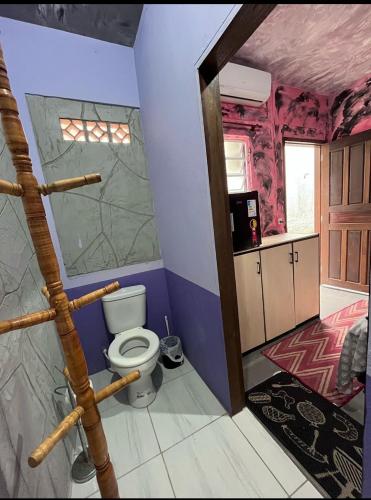 a bathroom with a toilet in a room at Hostel Boa Vista in Joinville