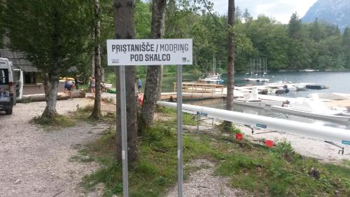 a sign in front of a marina with boats at Apartment Iris in Bohinj