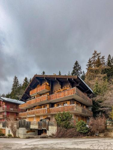 a building with balconies on the side of it at Centered Ski/Swim Ap. w/ private yard & fireplace in Anzère
