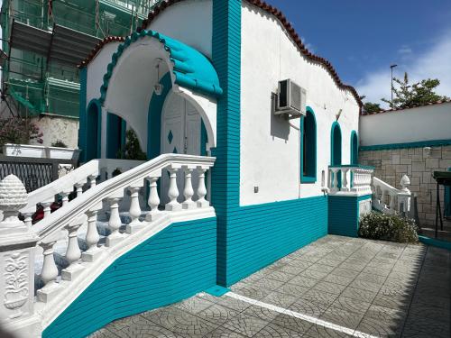 a blue and white building with a white staircase at Residence R&B Tyrrhenum in Monte di Procida