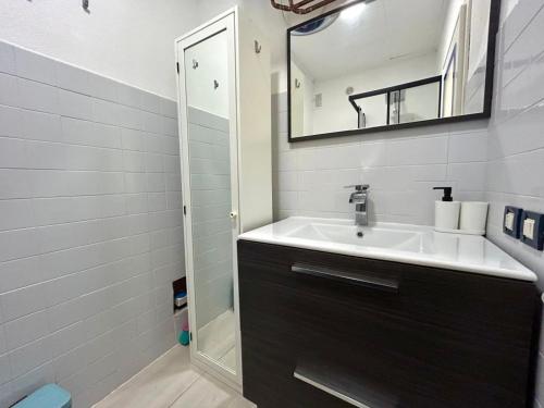 a bathroom with a sink and a mirror at Central View Loft in Lignano Sabbiadoro