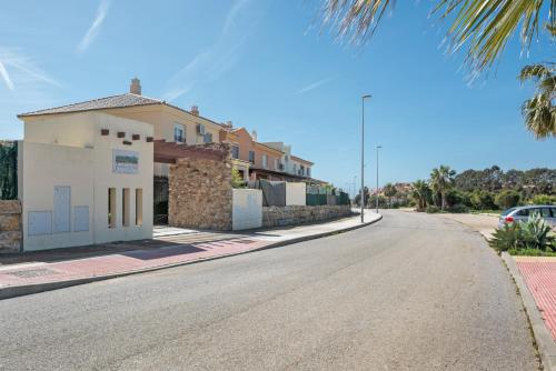 a street with a building on the side of a road at Bonita Casa Adosada in Zahara de los Atunes