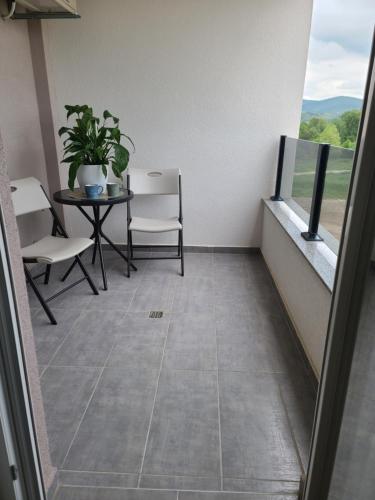 a balcony with a table and chairs and a window at Apartment Anna in Čapljina