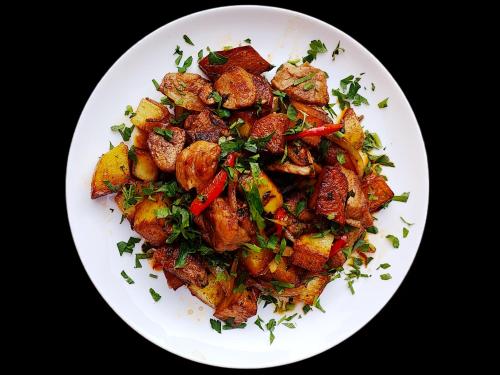 a plate of food with meat and vegetables at Areg Hotel in Yerevan