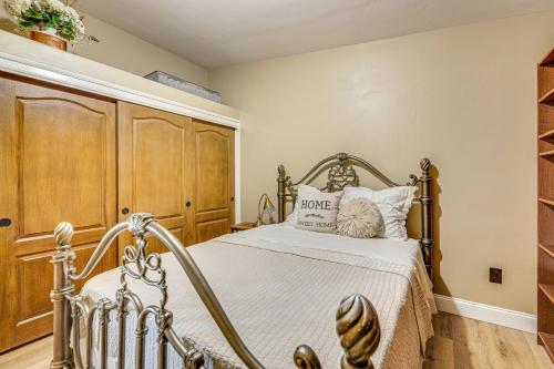 a bedroom with a bed and a wooden cabinet at Near Wineries and Dining Exquisite Menifee Home! in Menifee