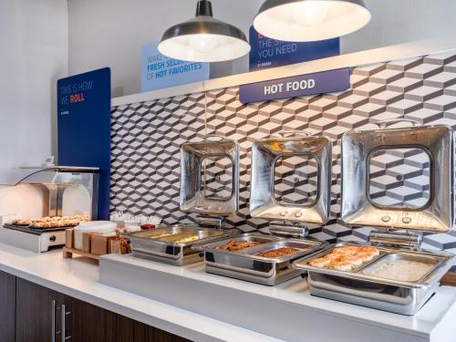 a buffet line with trays of food on a counter at Holiday Inn Express Lodi by IHG in Lodi