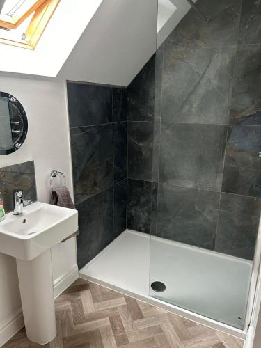 a bathroom with a shower and a sink at Hotdog House Filey Detached Pet Friendly Eco-House in Hunmanby