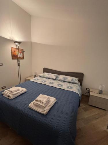 a bedroom with a bed with two towels on it at Casa Andrea Cefalù in Cefalù