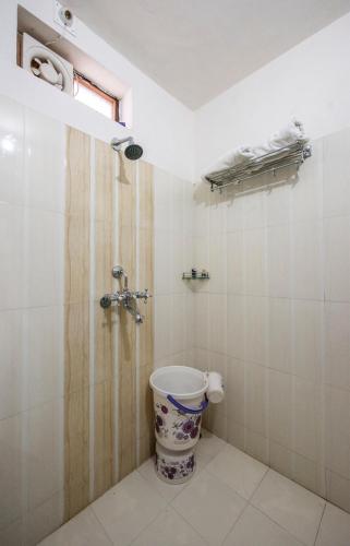 a bathroom with a toilet and a shower at Braj Villa in Udaipur