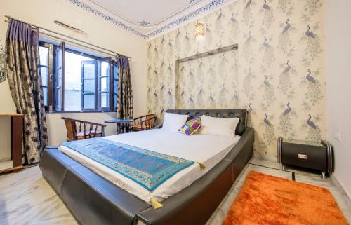 a bedroom with a bed and a window at Braj Villa in Udaipur